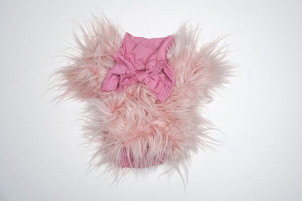 Pink fluffy outfit with bow detail.