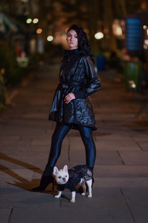 Woman in stylish outfit with small dog.