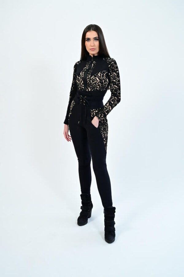 Model in stylish black outfit and boots.