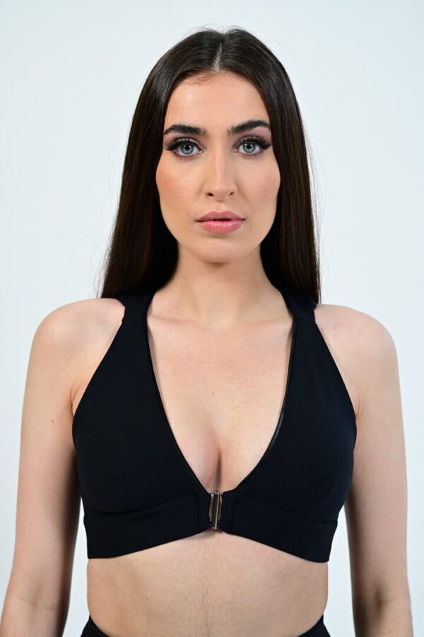 Woman wearing a black halter top.