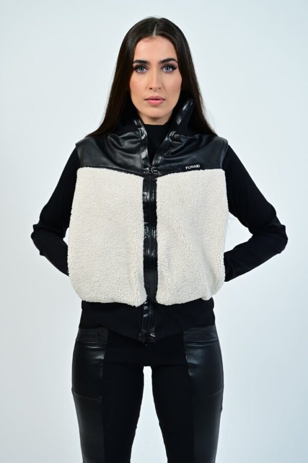 Woman wearing a stylish black and white vest.