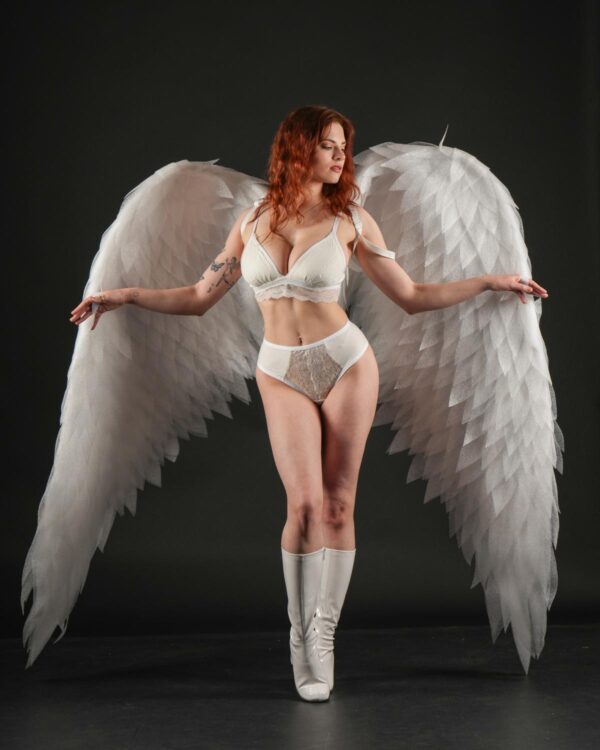 Redhead angel in white lingerie and boots.
