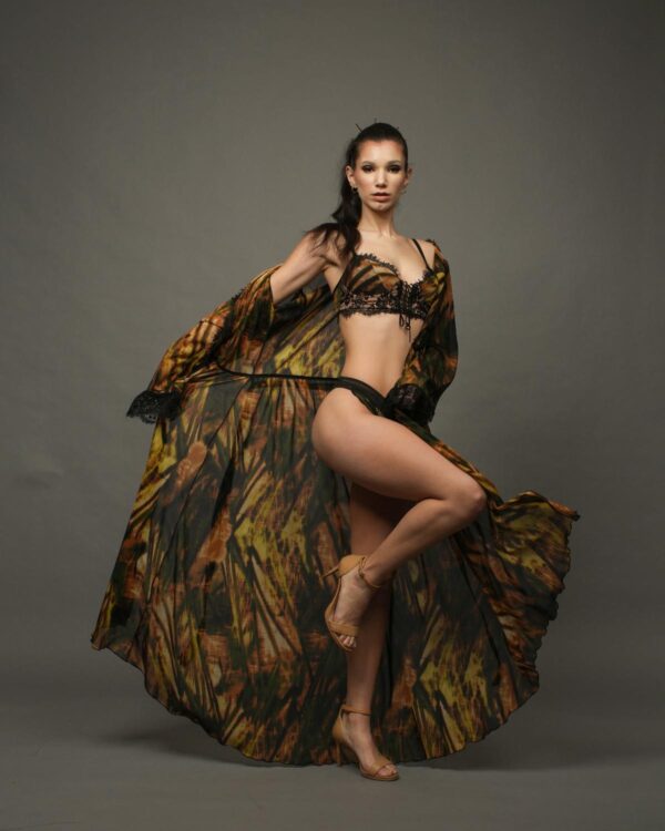 Model in flowing patterned garment and lingerie.