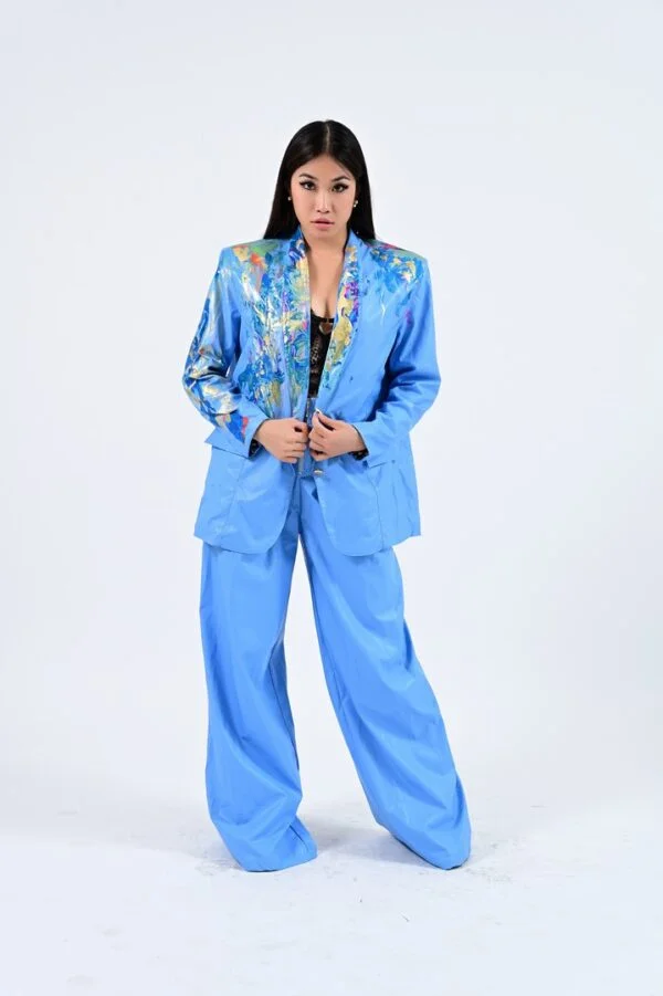 Woman in light blue painted suit.