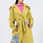 Woman in yellow painted trench coat