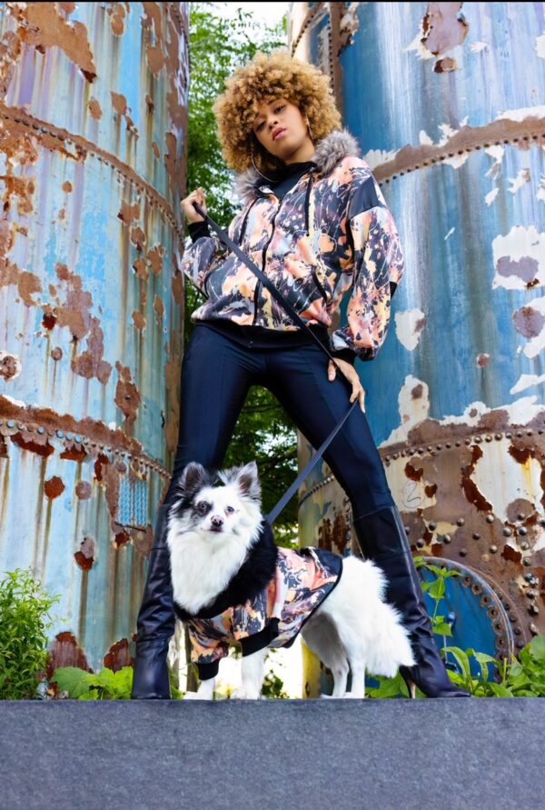 Fashionable woman poses with a dog.