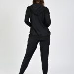 Person in black activewear facing away.