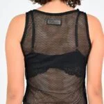 Woman in black mesh sleeveless top.