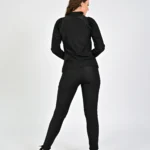 Woman in black activewear, facing away.