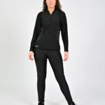 Woman in black athletic outfit standing confidently.